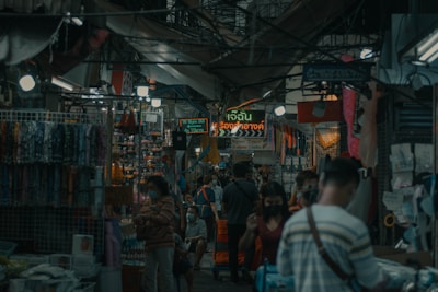 A friendly interpreter assisting a traveler with translation in a bustling market.
