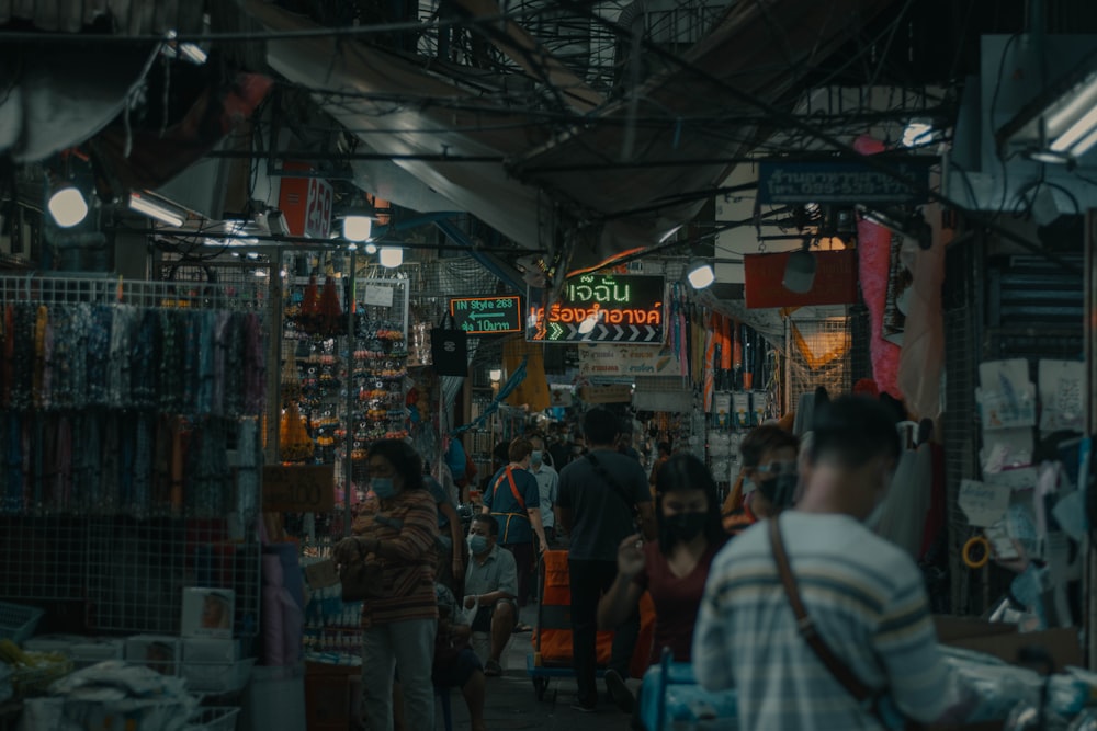 a group of people walking through a market