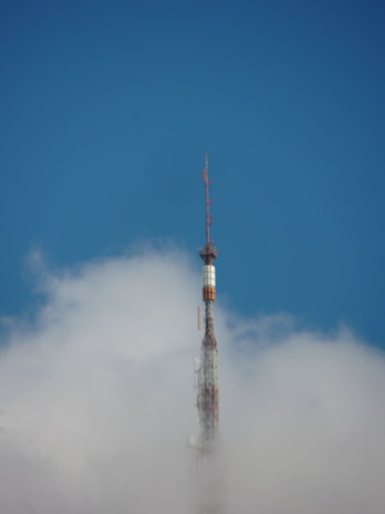 An outdoor antenna tower reaching into a clear blue sky on a sunny day.