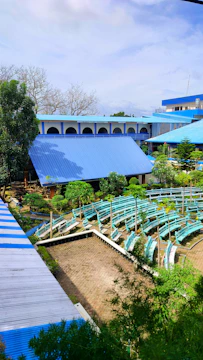 A rustic auditorium built by locals in the barren land of Ganjno2 under a vast open sky.