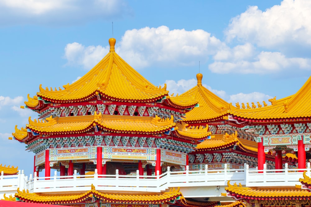 a large building with yellow and red roof tops