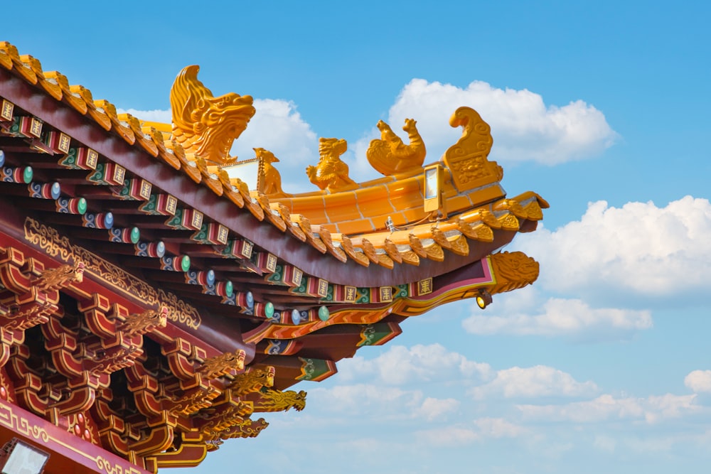 the roof of a building with golden decorations on it