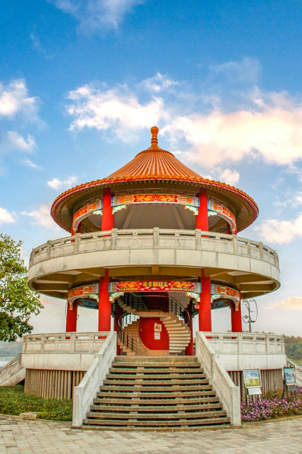 a building with a red and white roof and stairs