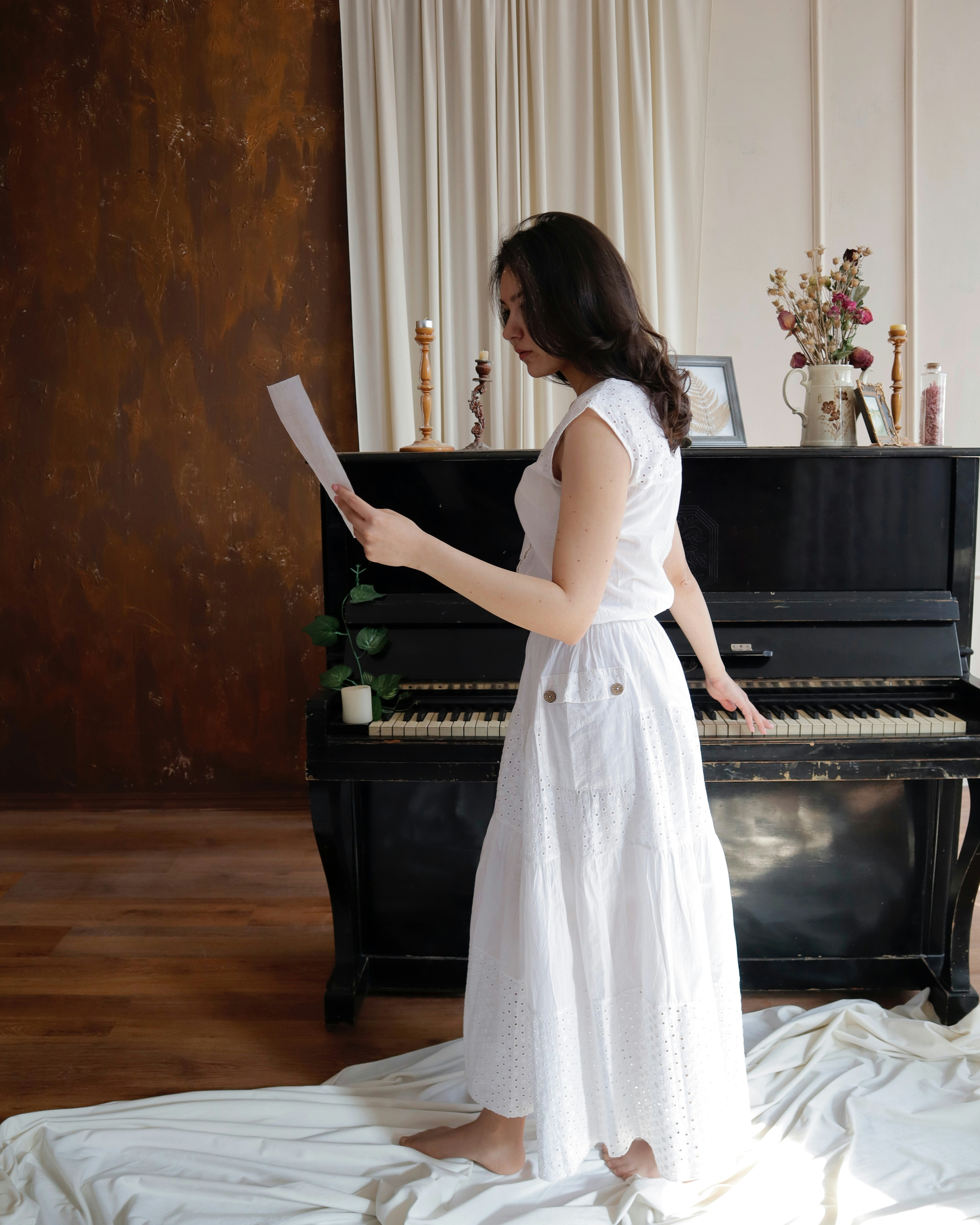 a woman standing in front of a black piano