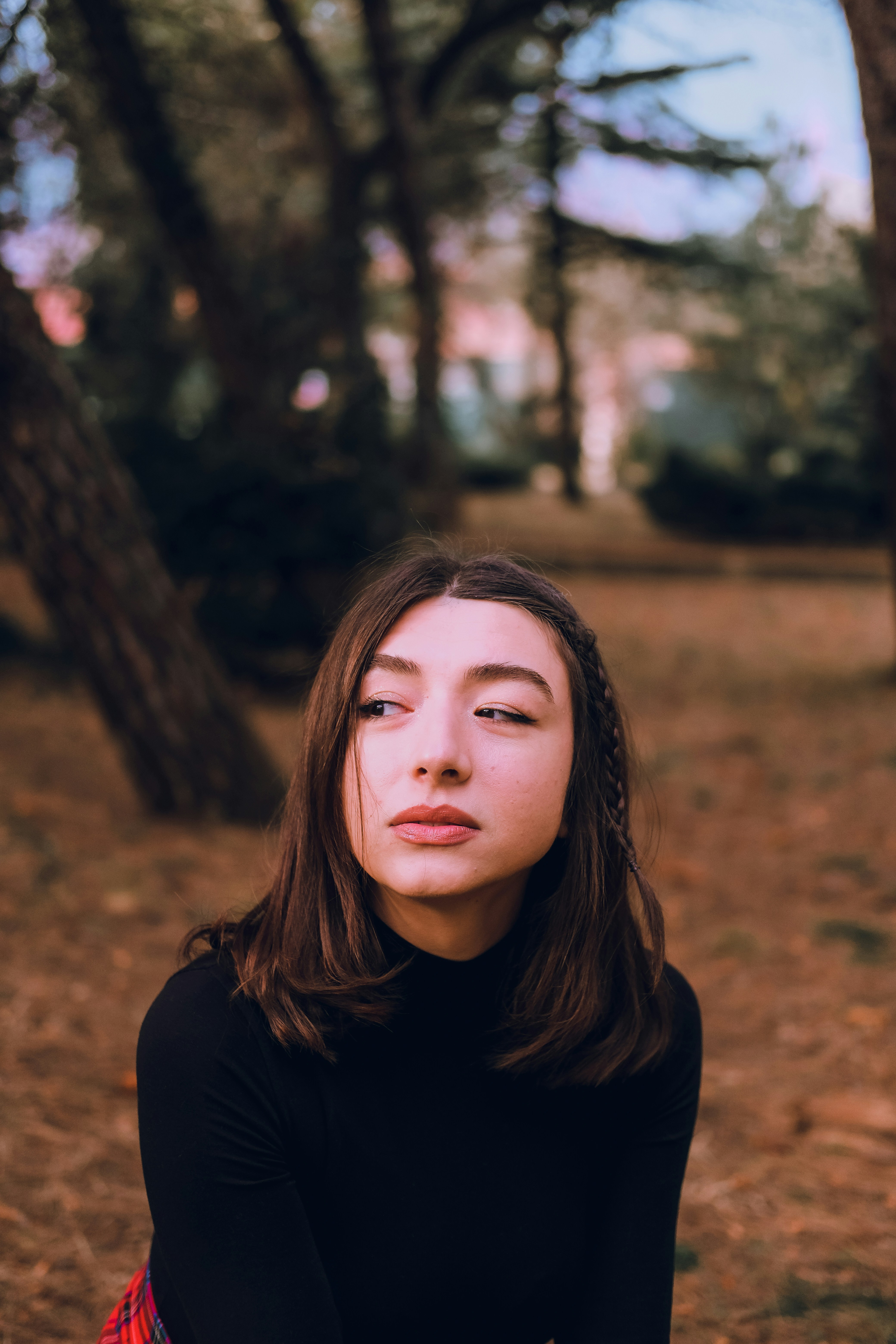 a woman sitting on the ground with her eyes closed