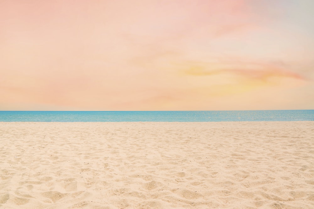 a sandy beach with footprints in the sand