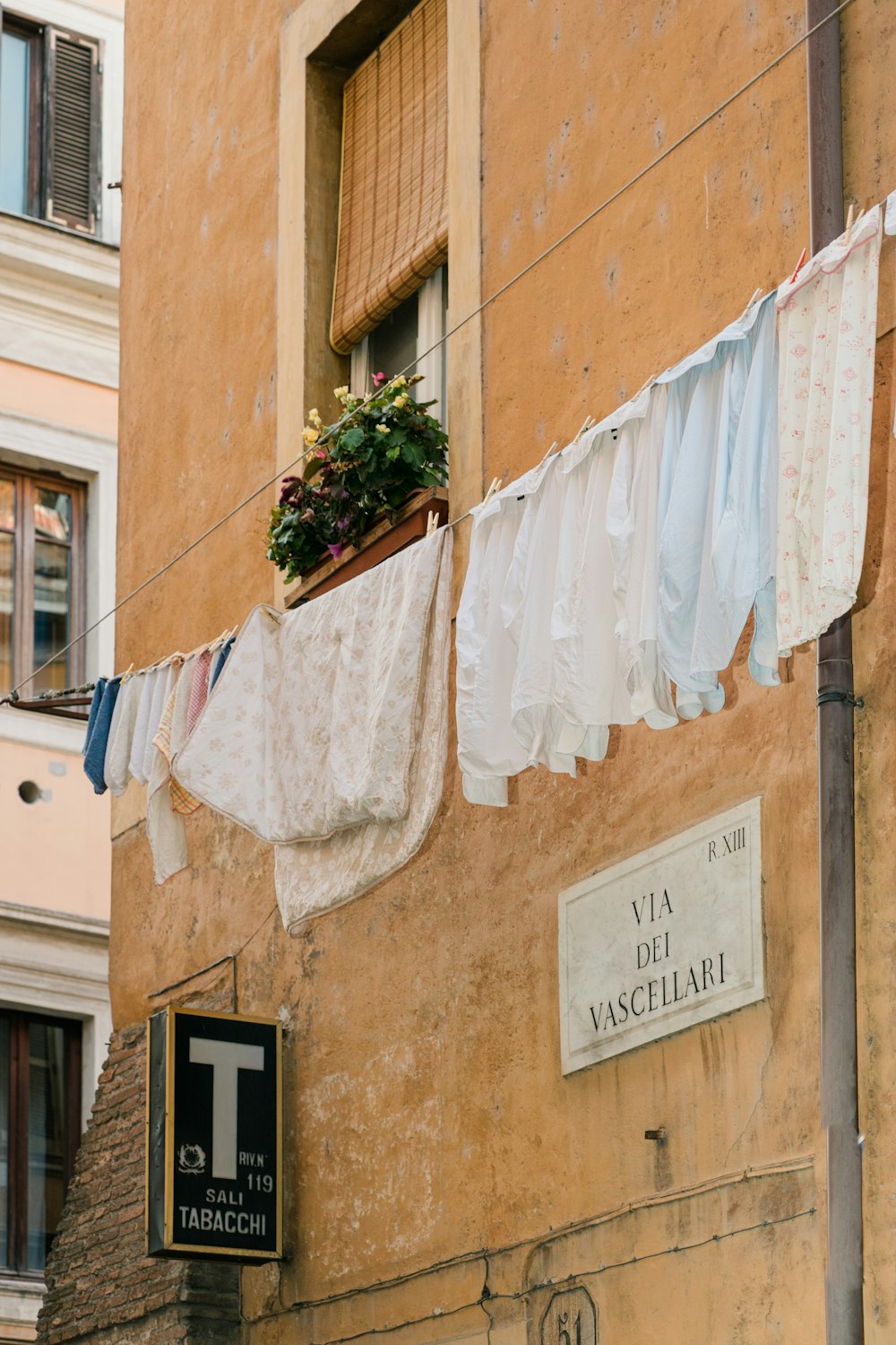 clothes hanging on a clothes line outside of a building