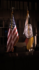 A group of diverse Floridians holding a red, white, and blue banner with the Florida state flag in the background.