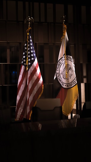 A group of diverse Floridians holding a red, white, and blue banner with the Florida state flag in the background.