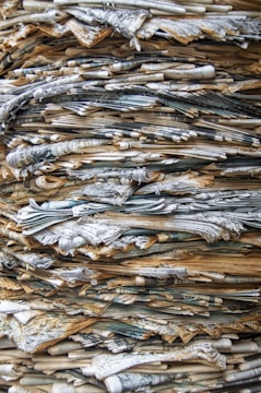 Stack of classic newspapers with visible date stamps.
