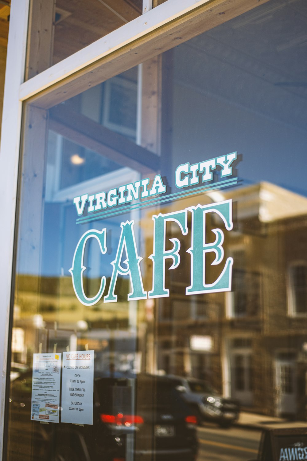 a window with a sign that says virginia city cafe