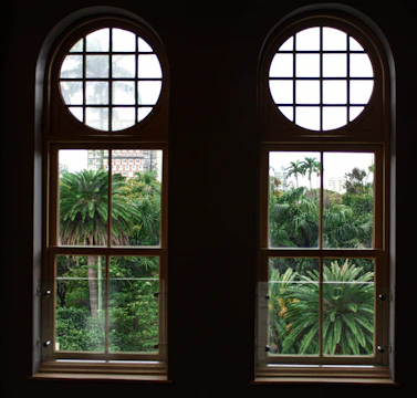 Elegant living room with floor-to-ceiling windows overlooking tropical gardens in Cap Cana