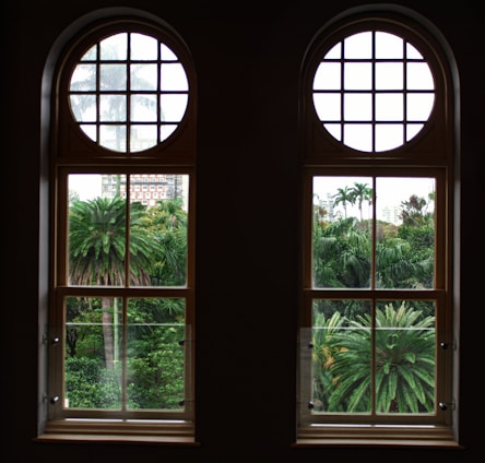 A bright, modern two-bedroom condo with large windows overlooking a lush garden.