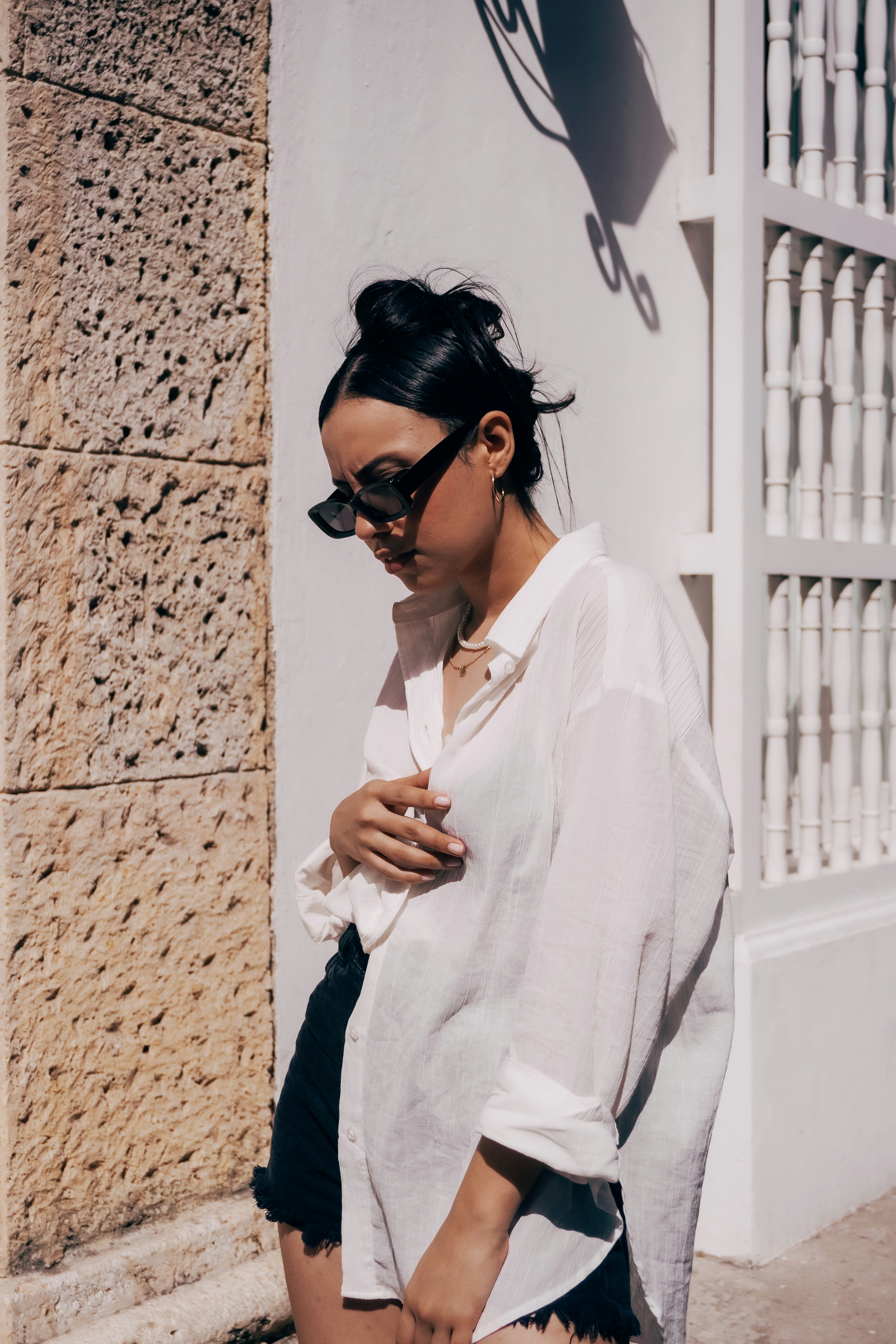 a woman in black shorts and a white shirt