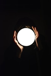 a person holding a light in their hands