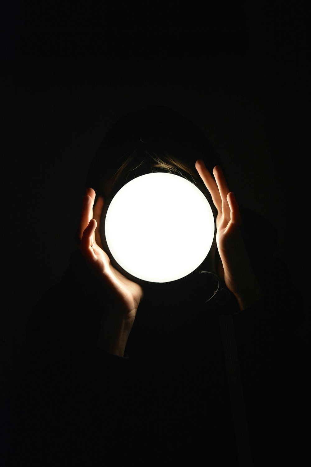 a person holding a light in their hands