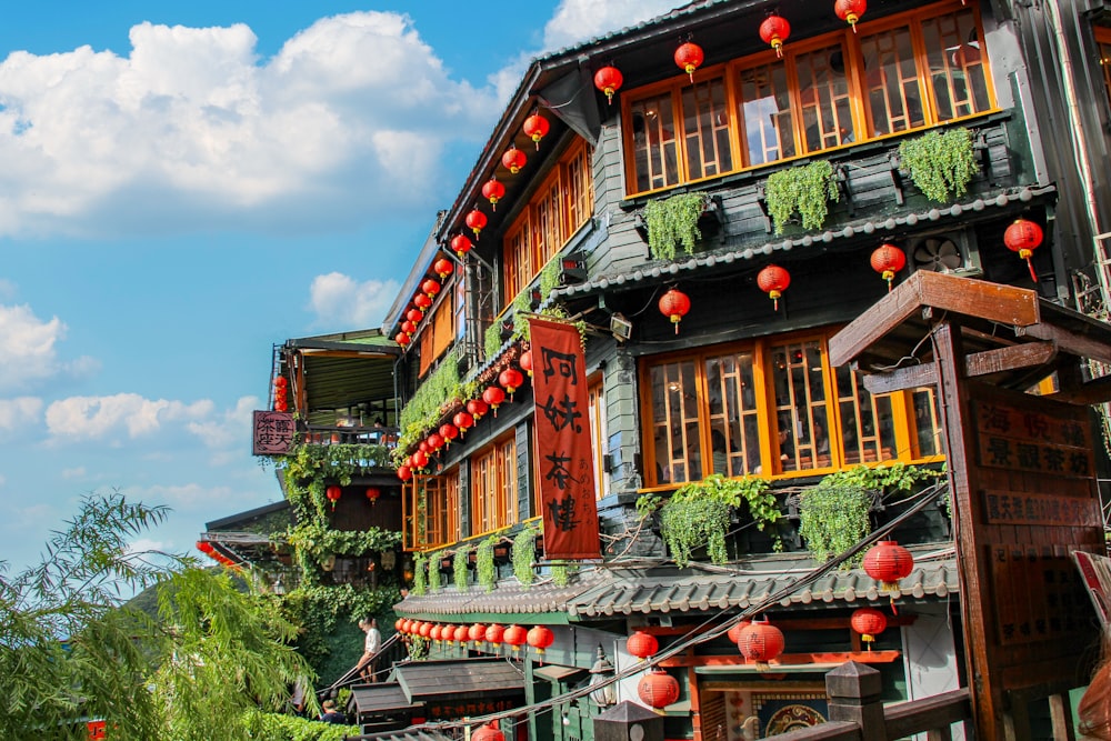 a row of buildings with red lanterns hanging from them