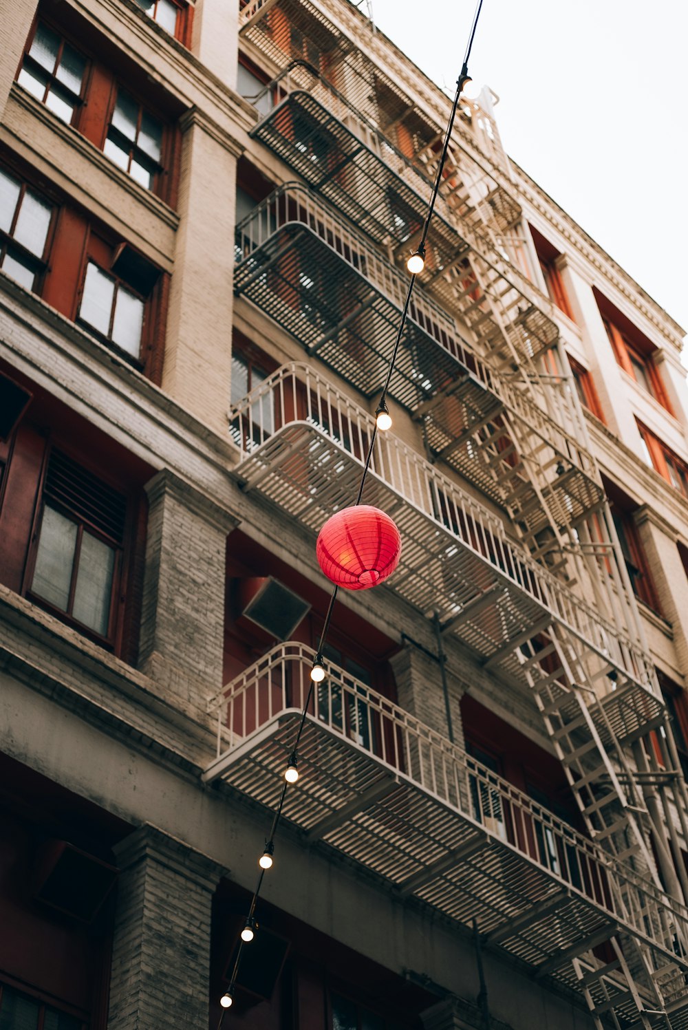a red ball is hanging from a fire escape