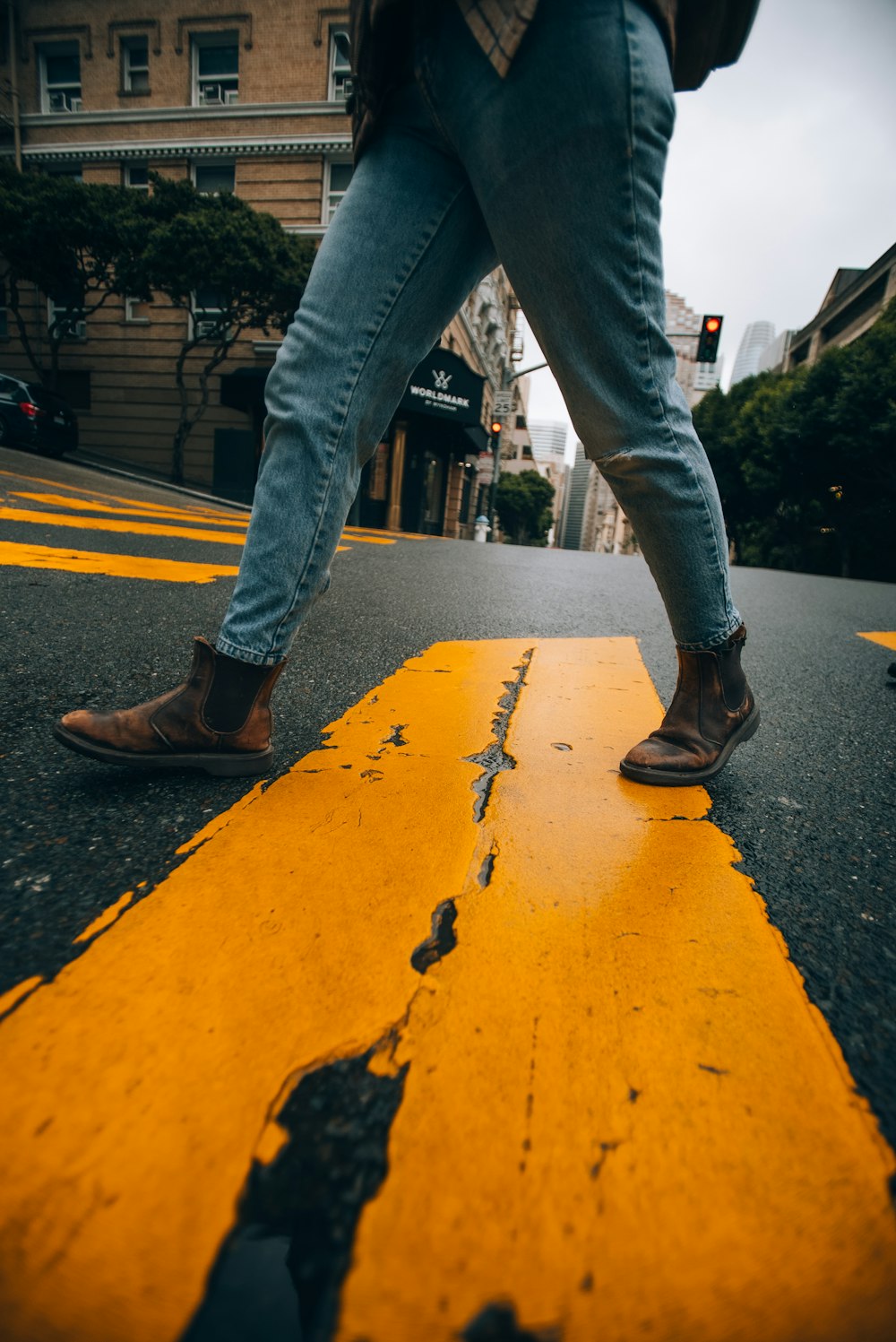 a person walking across a yellow painted street