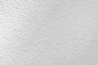 Close-up of a freshly finished stucco wall showcasing smooth texture and clean edges.