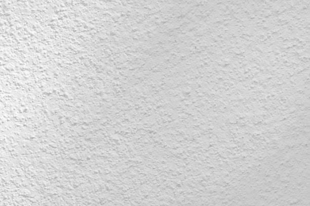 Close-up view of elegant plaster and stucco wall finishes in a modern interior.