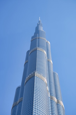 A towering skyscraper gleaming under sunlight, showcasing pristine glass panels.