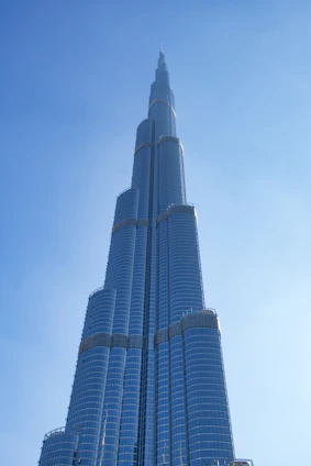 A sleek, modern skyscraper under construction against a clear blue sky, symbolizing growth and sophistication.