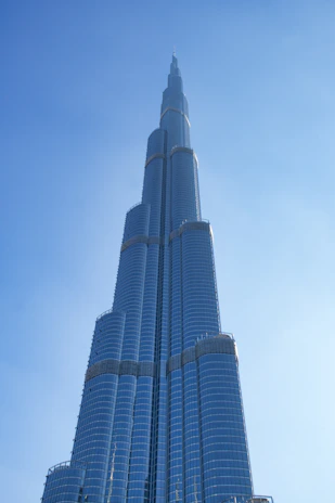 A sleek, modern skyscraper symbolizing economic progress under a clear blue sky.