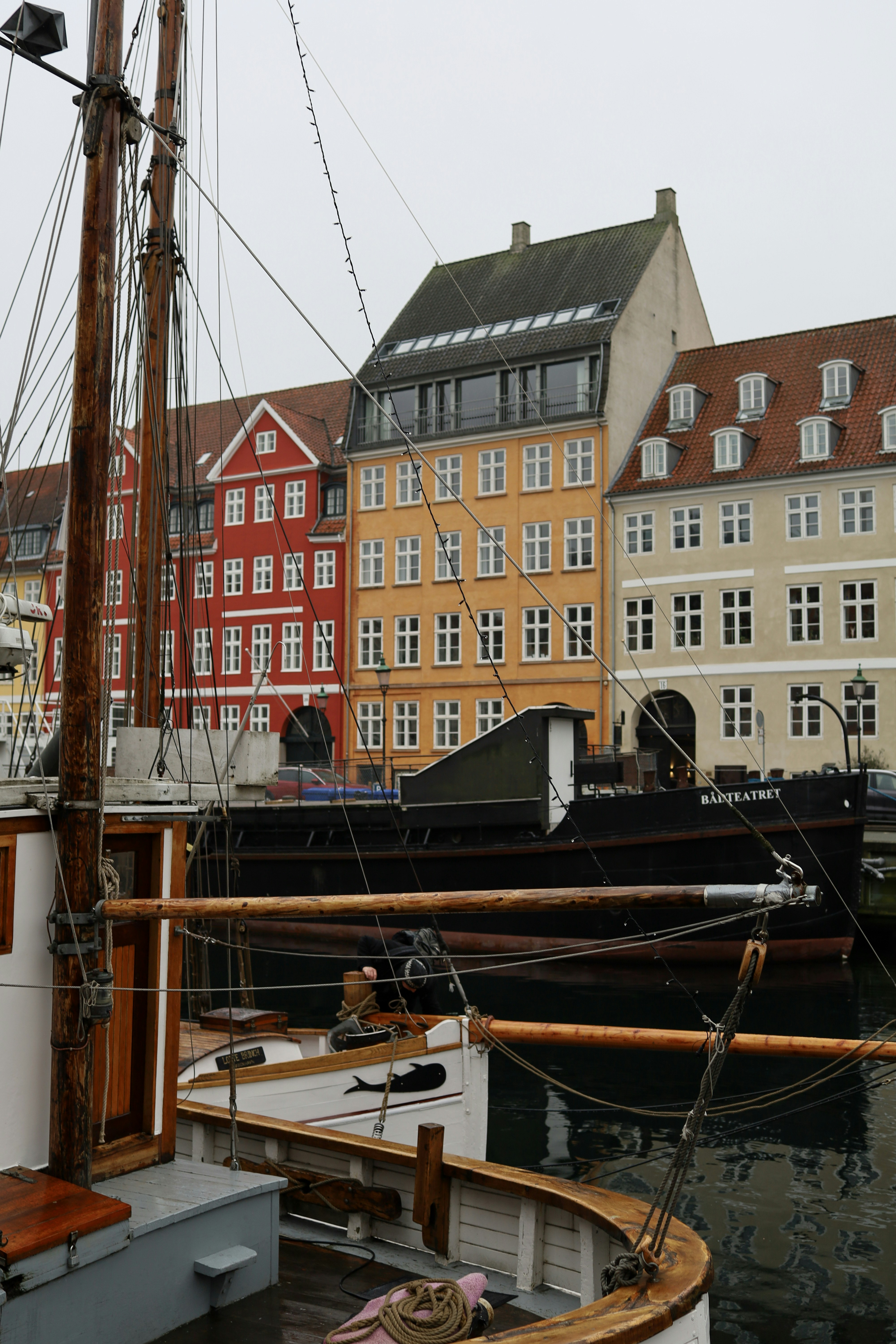 a boat docked in a harbor with buildings in the background