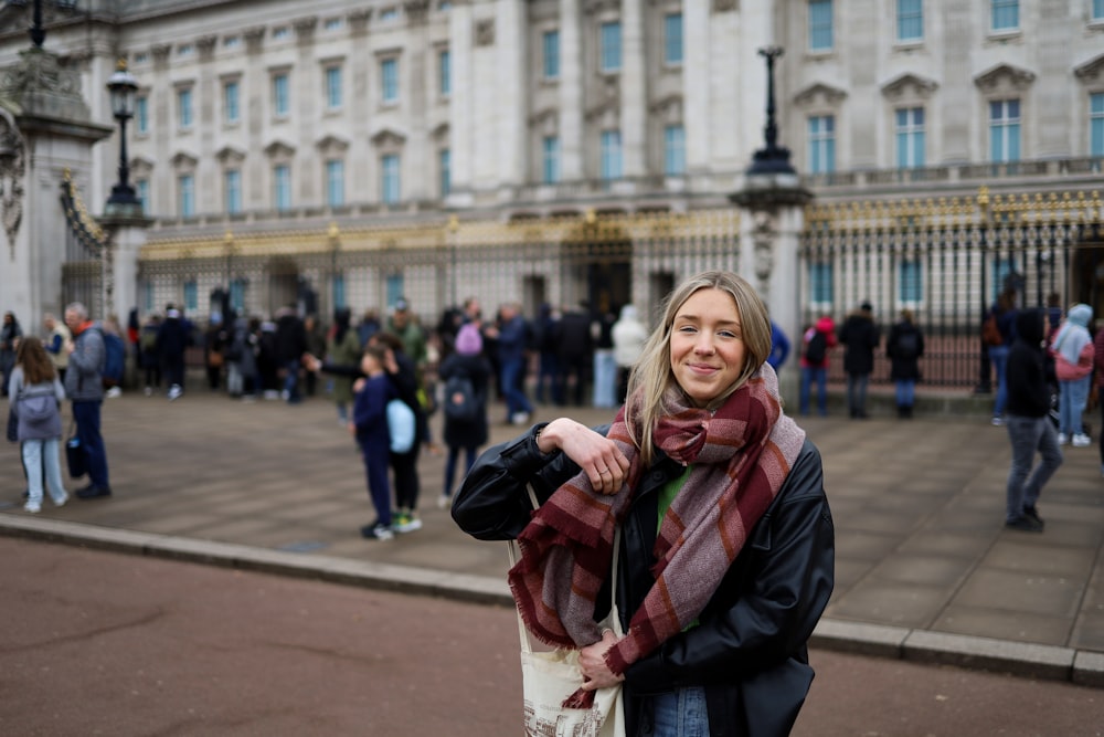 a woman standing in front of a large building