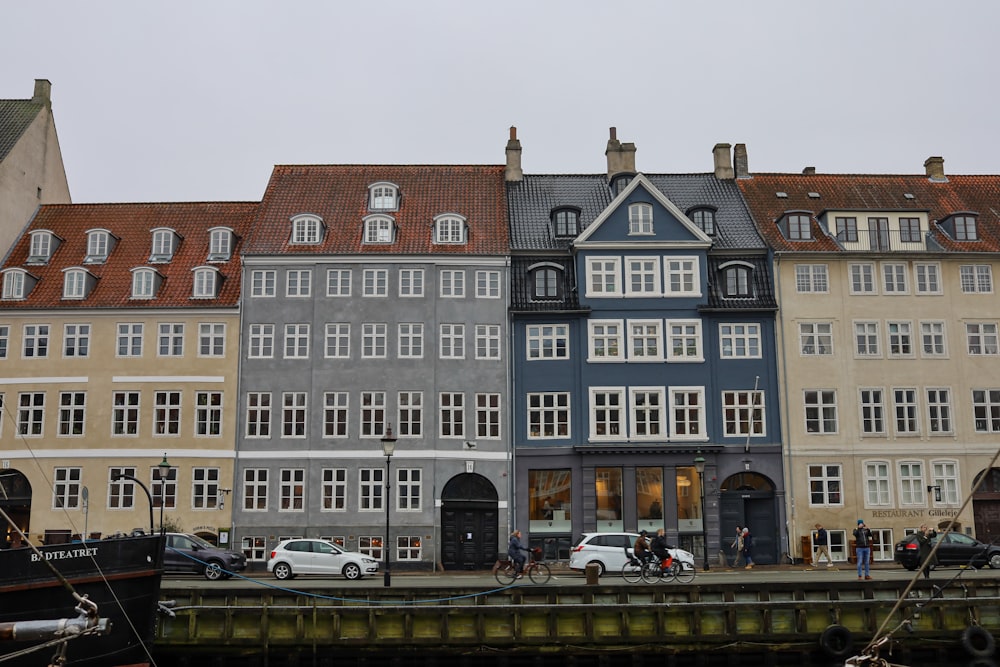 a row of buildings next to a body of water