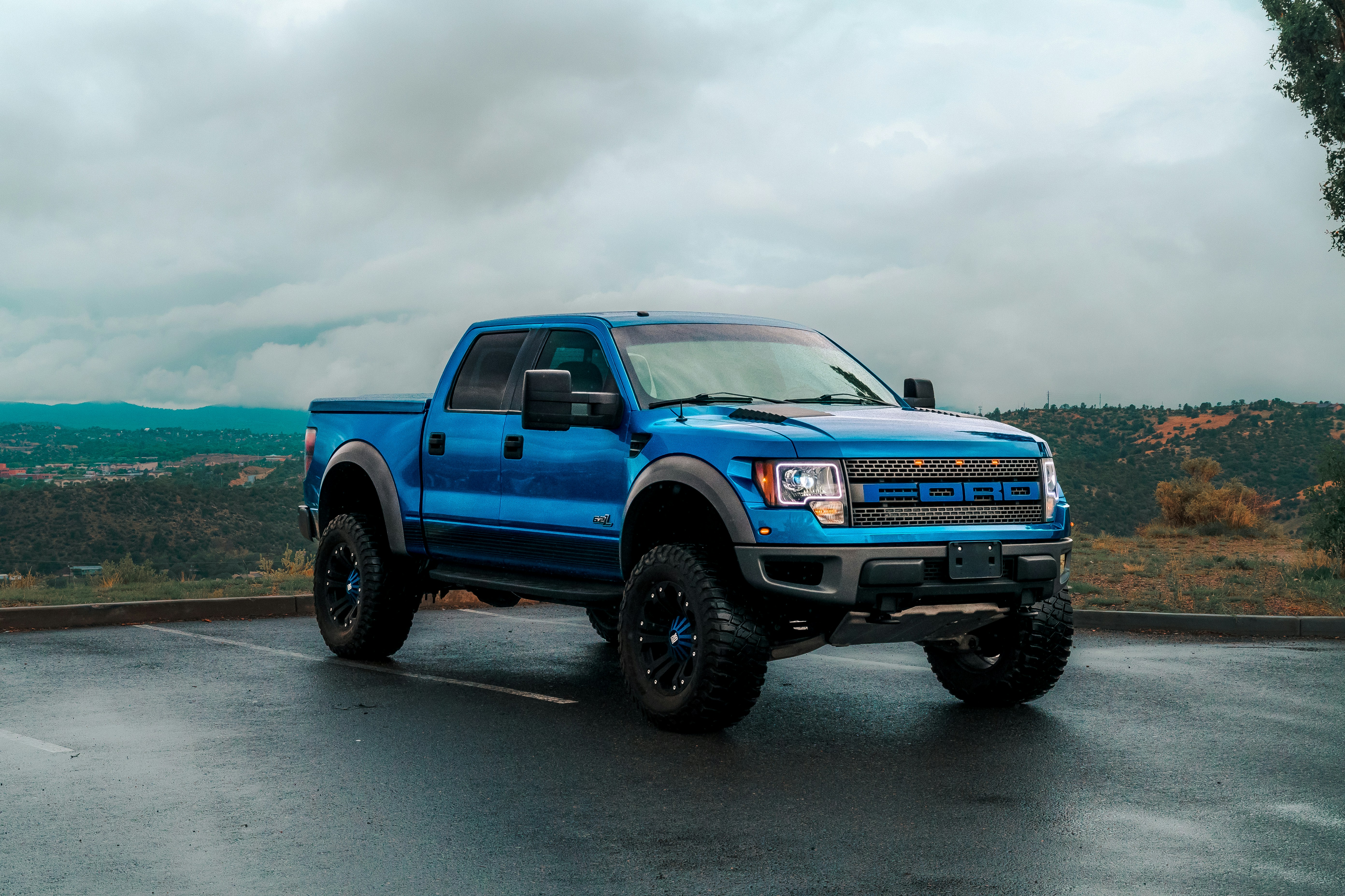 a blue truck parked in a parking lot