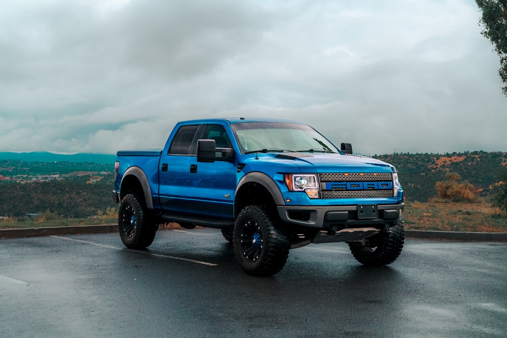 a blue truck parked in a parking lot