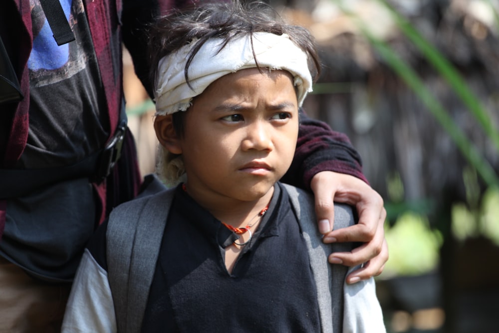 a young boy with a blindfold on his head