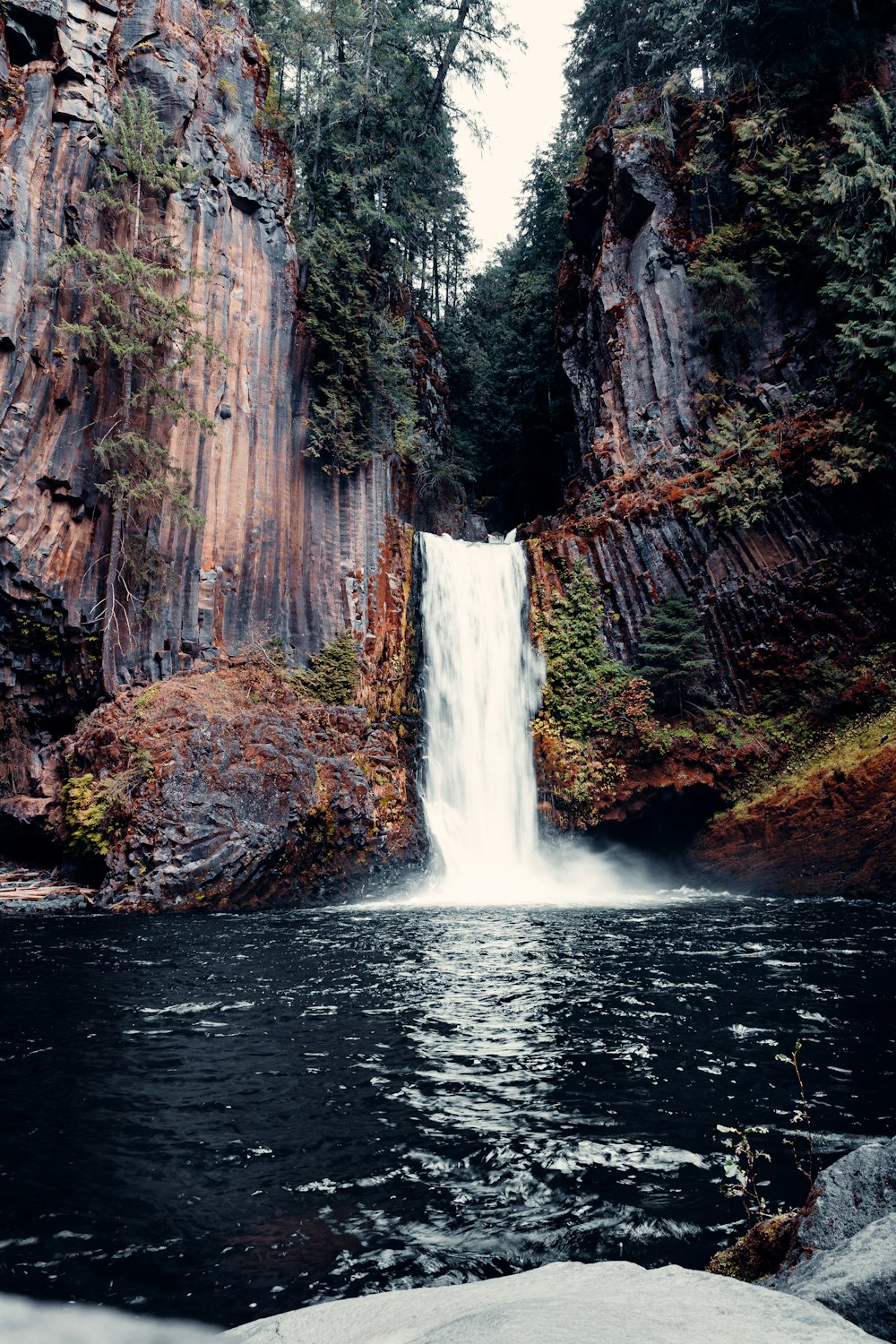 a waterfall with a waterfall cascading into it