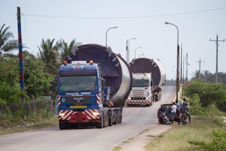 a couple of large trucks driving down a road