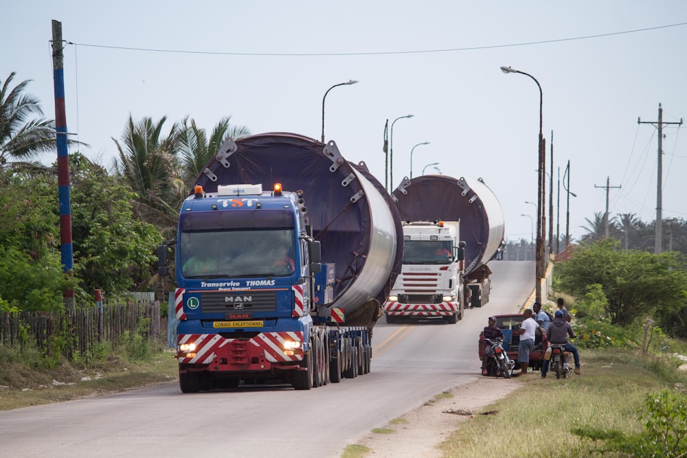 a couple of large trucks driving down a road