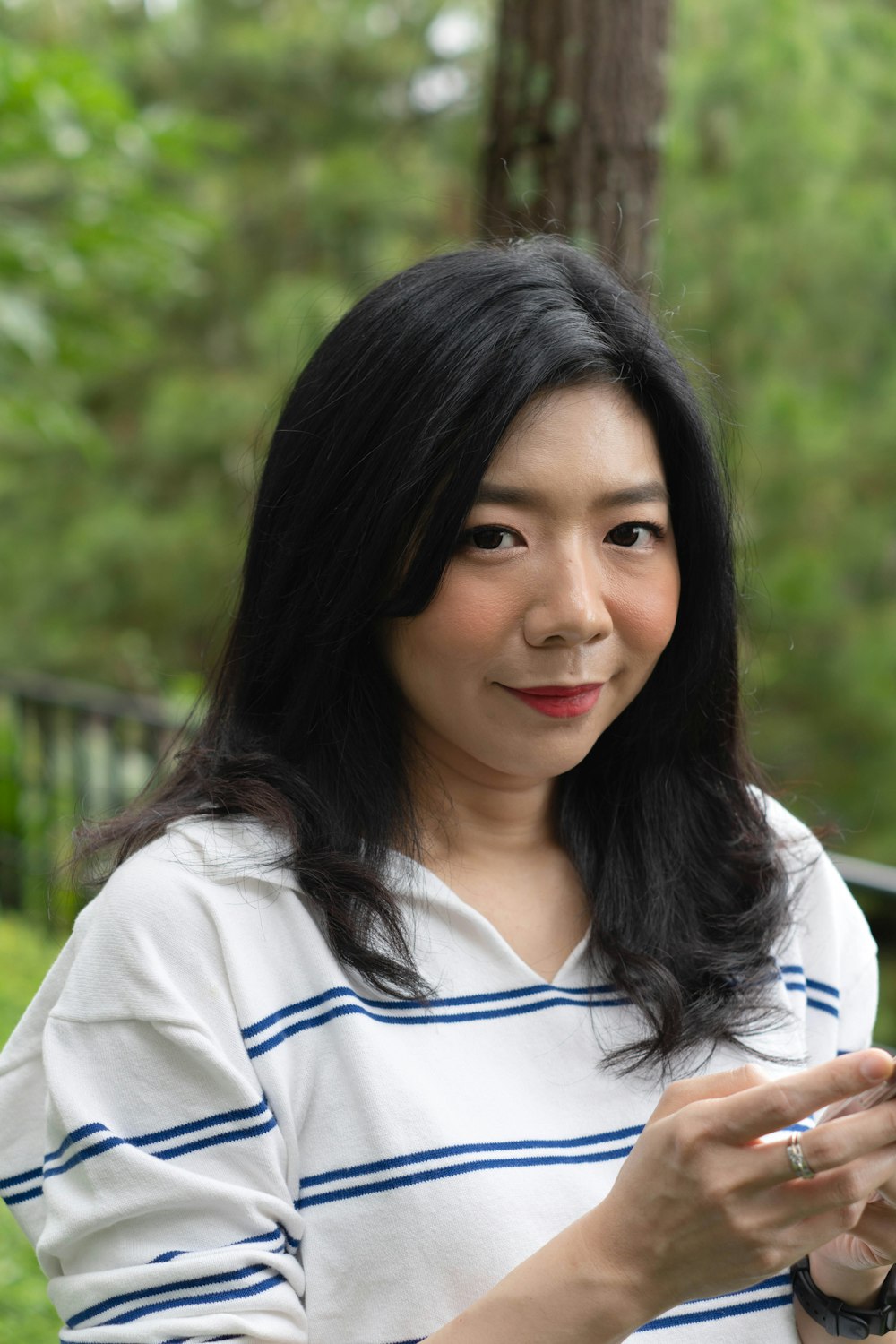 a woman holding a smart phone in her hands