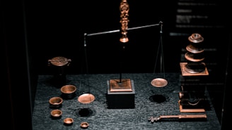 a display case with a scale, cups, and other items