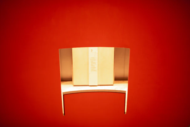 A sleek, modern minimalist desk with clean lines and a smooth surface in a bright, airy room.