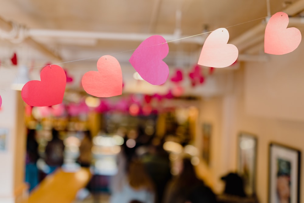 a string of paper hearts hanging from a ceiling