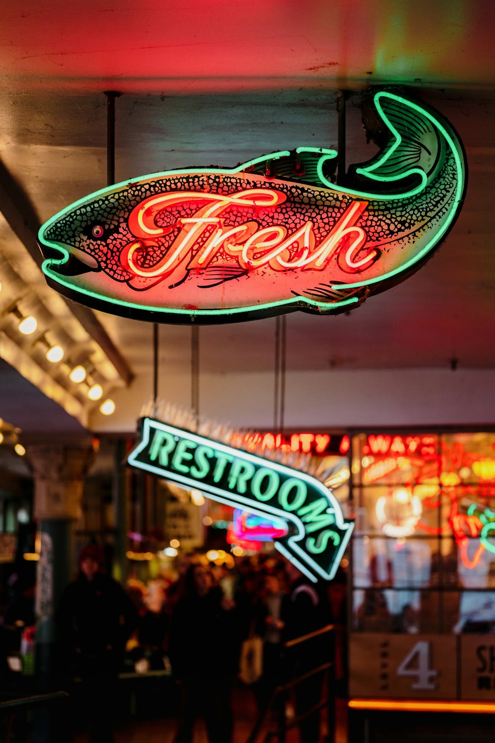 a neon sign hanging from the ceiling of a restaurant