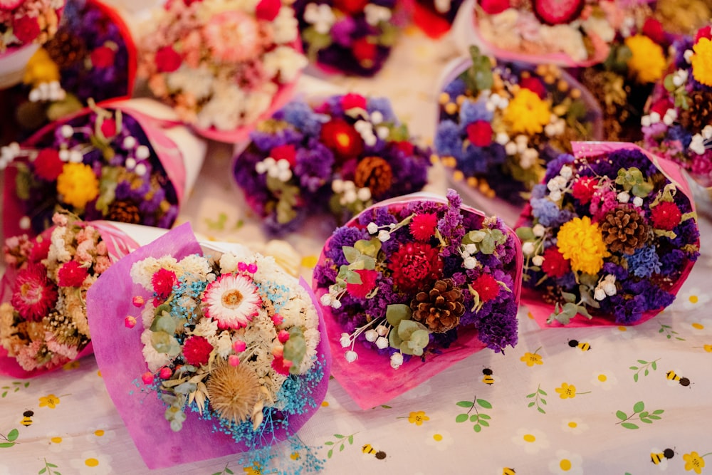 a table topped with lots of colorful flowers