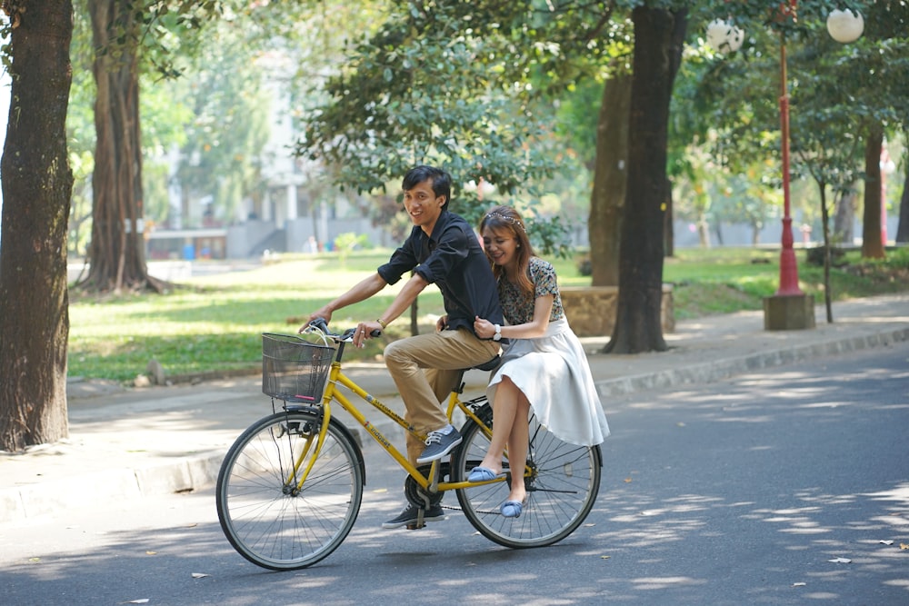 a man and a woman riding a bike together