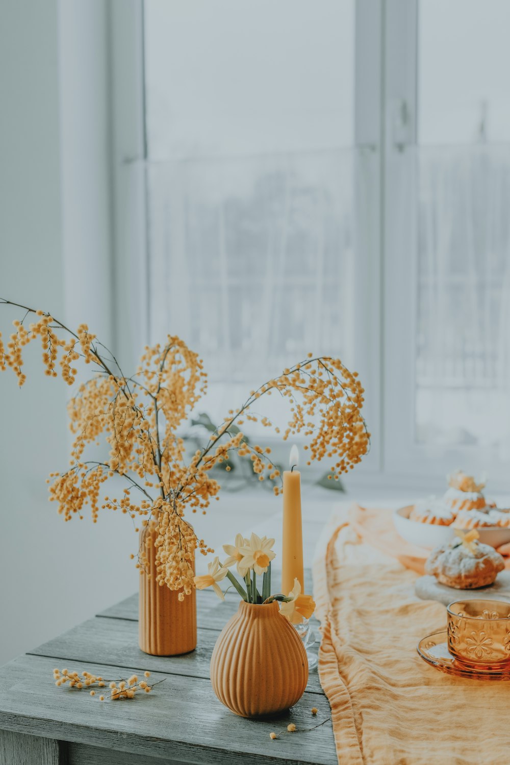 a table topped with vases filled with yellow flowers