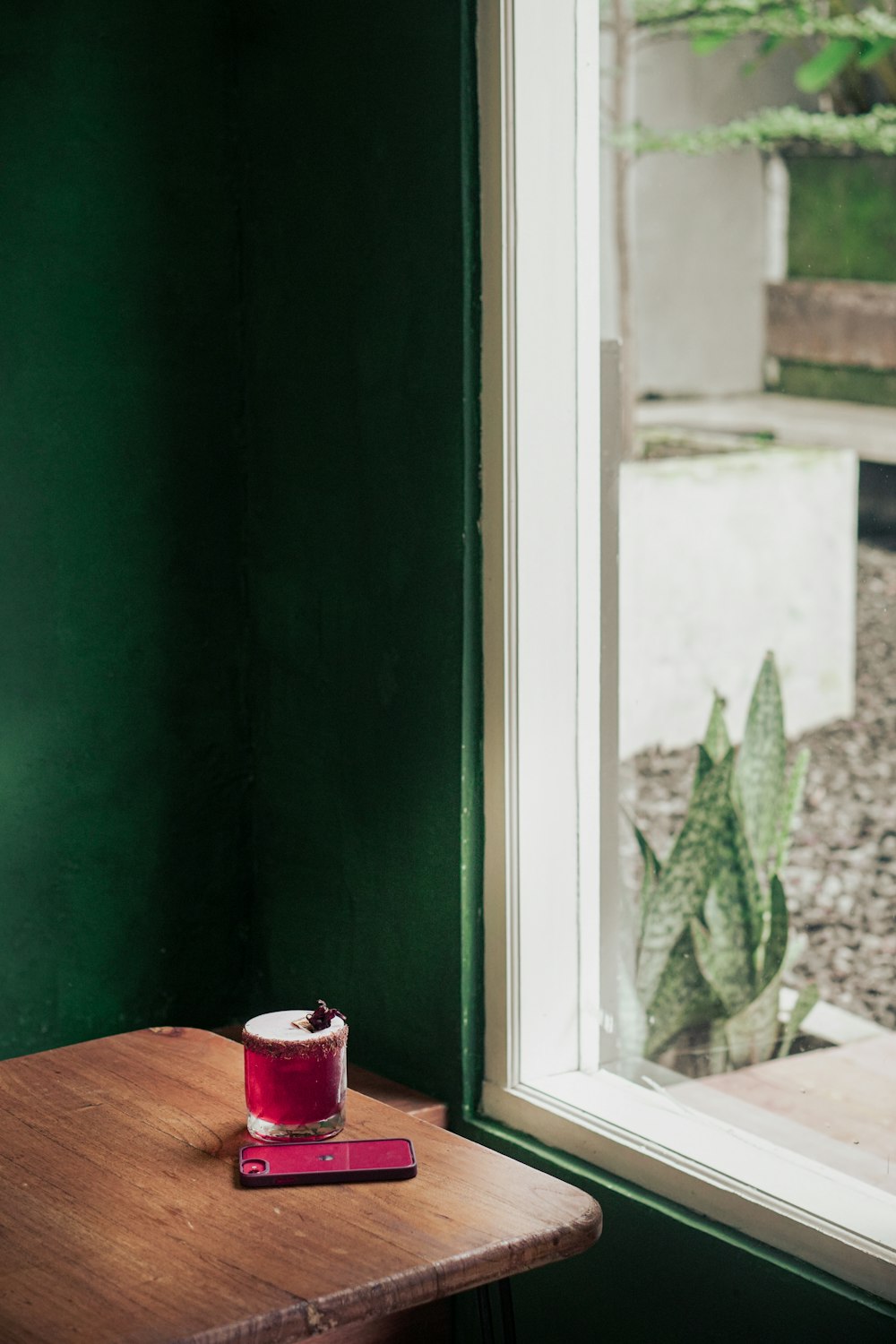 a cup of coffee sitting on top of a wooden table