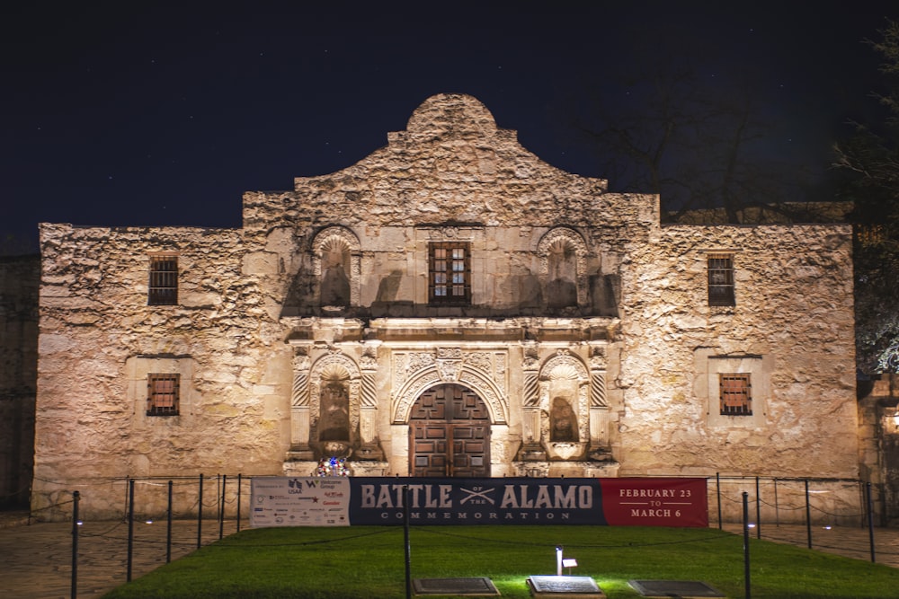 a large stone building with a sign in front of it