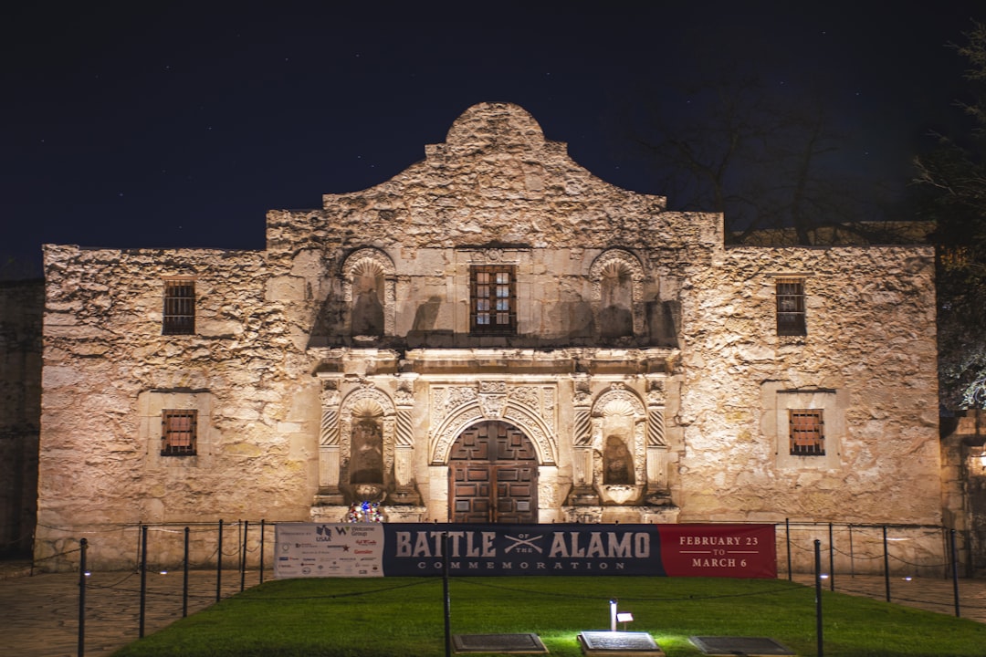a large stone building with a sign in front of it,