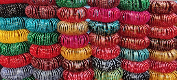 Colorful bangles stacked neatly, catching the light beautifully.