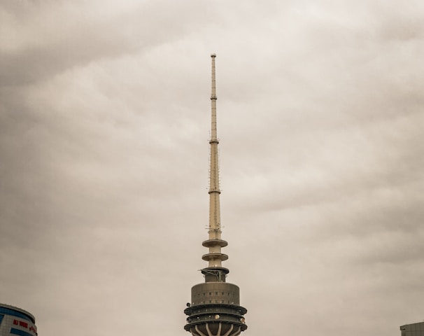 a very tall building with a very tall tower in the background